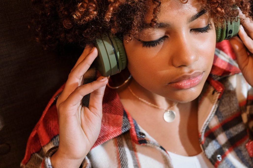 A woman listening to music on her headphones