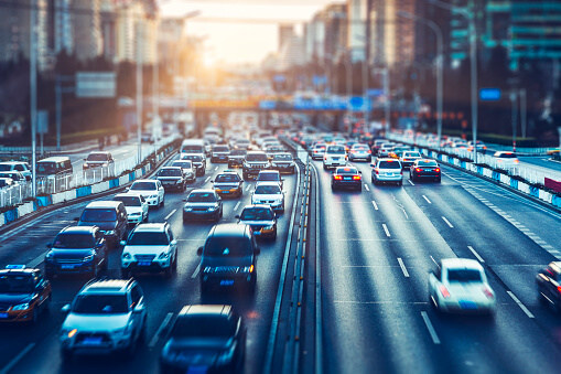 A busy motorway of traffic on both sides.